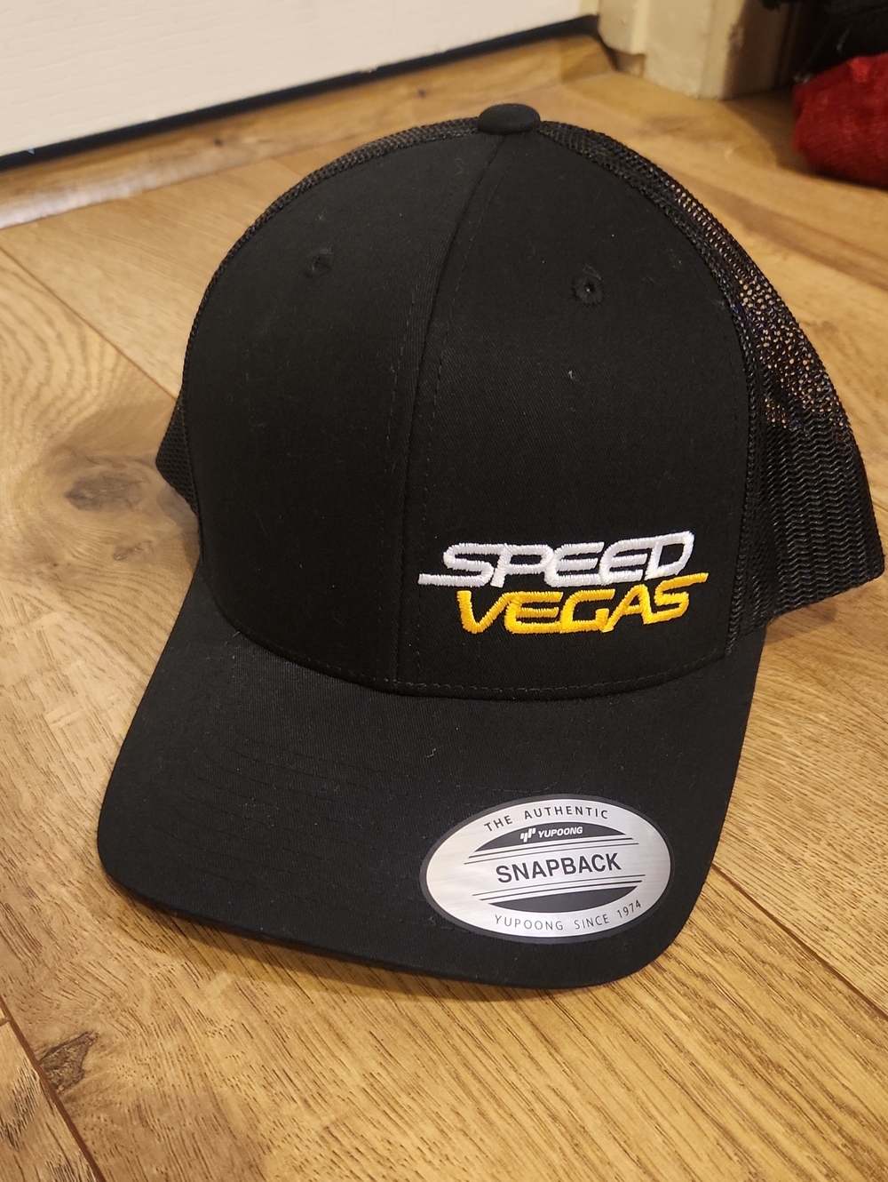 The Classic Black Snapback Hat with White and Yellow Embroidered Logo